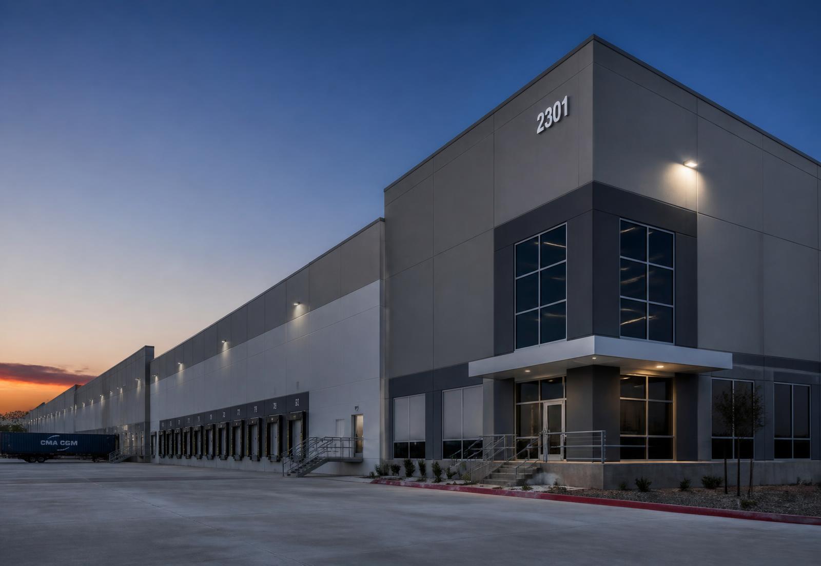 Modern industrial distribution facility with loading docks at dusk